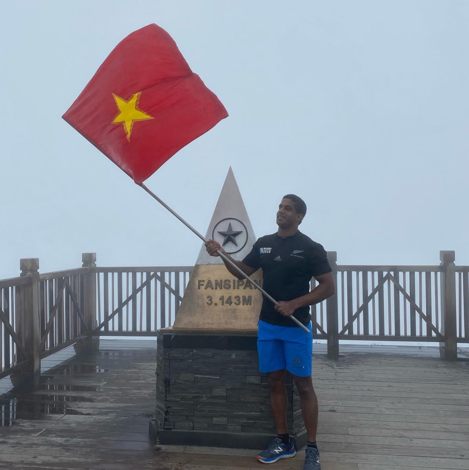 Robin of Baba’s Kitchen holding up the flag in Vietnam